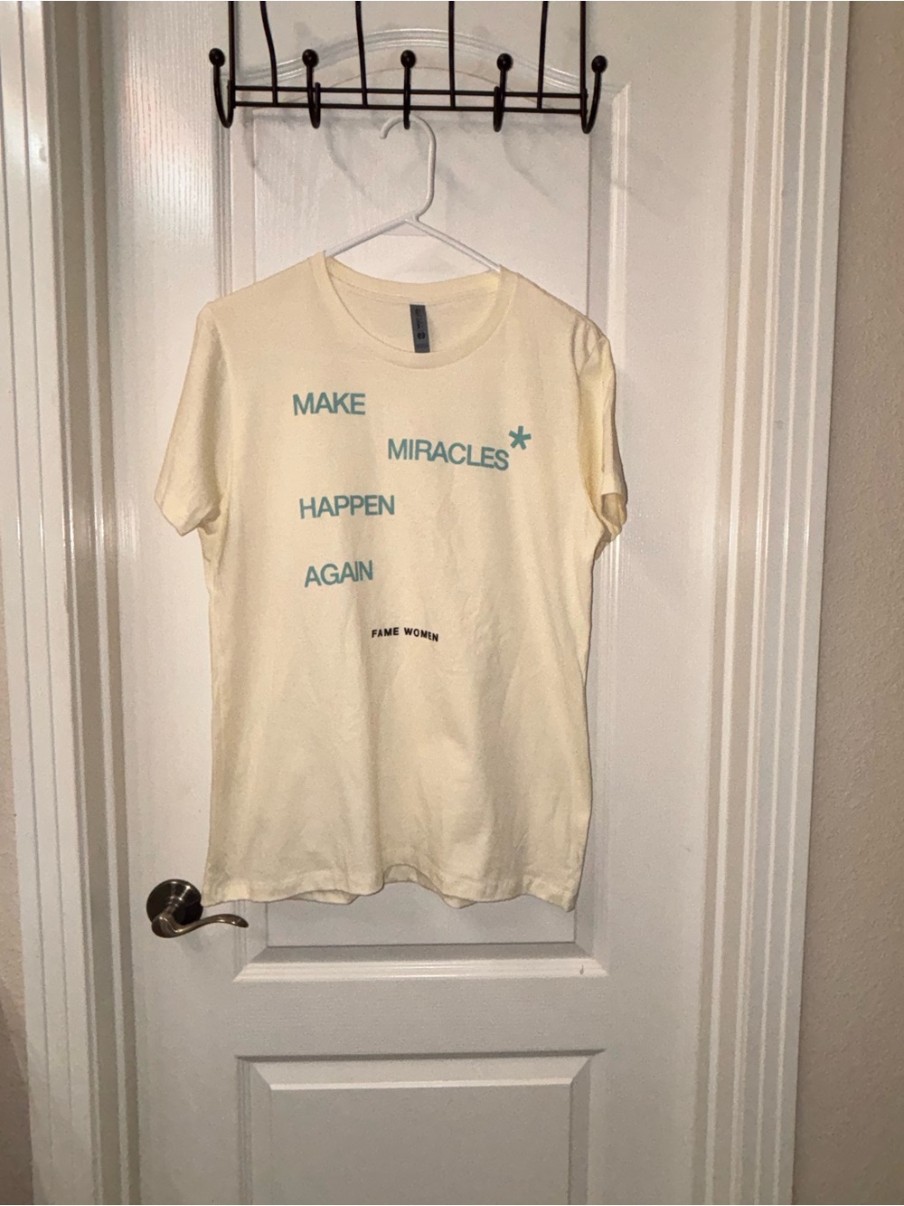 Next Level Apparel Cream Tee with Teal Graphic